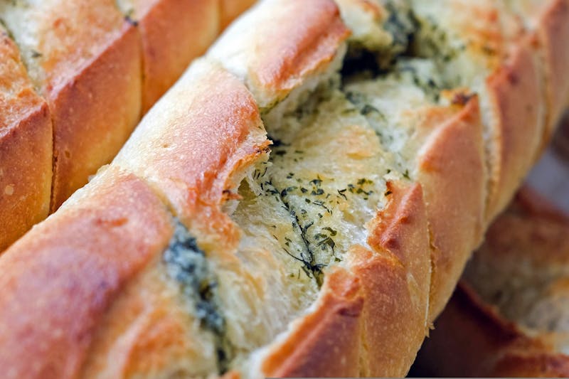 Garlic Bread with herbs and melted butter at Marcos